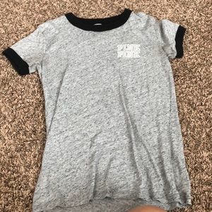 Grey T-shirt with black outline on sleeves & neck